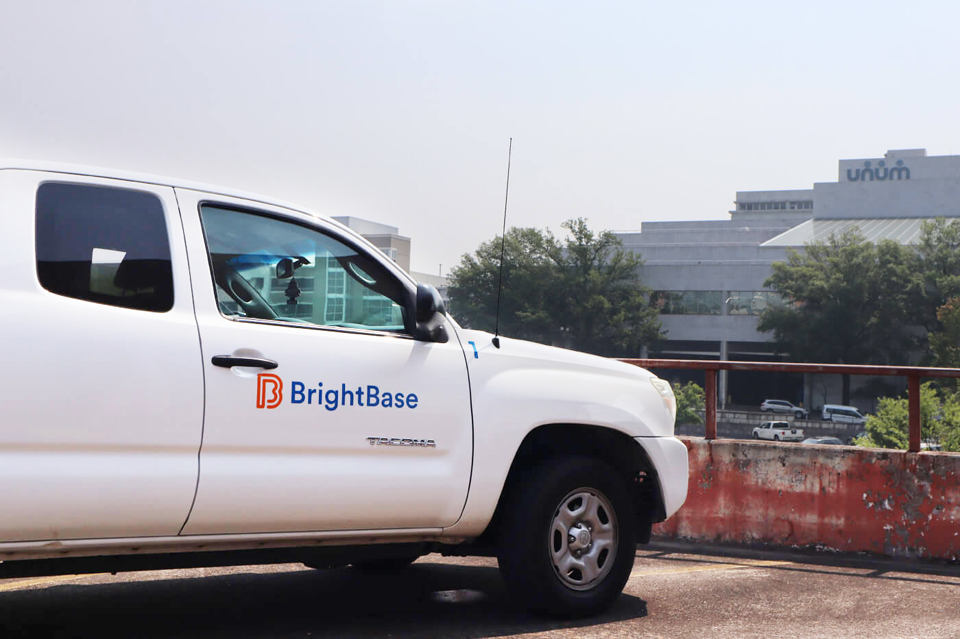 BrightBase truck parked on top of a parking garage overlooking the city.